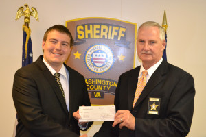 Washington County Sheriff Fred Newman (r) presents Austin McClure with a VSI scholarship check.