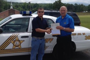 Wise County Sheriff Ronnie Oaks has presents Robert Stidham of Appalachia, VA with a scholarship check for $1,000.