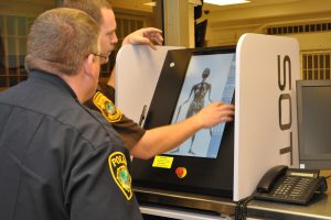 Lt. R. Summerford demonstrates the body scanner to Newport news Police Dept. command staff.
